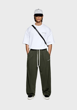 MKI Miyuki Zoku Olive Wide Fit Track Pants. Model shot.