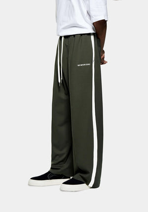 MKI Miyuki Zoku Olive Wide Fit Track Pants. Model Shot. 