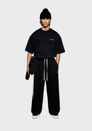 Wide fit track pants MKI Miyuki Zoku black. Model shot.