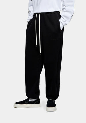 Relaxed Fit 800 GSM Superweight Cuffed Joggers by MKI MIYUKI ZOKU at EQVVS Menswear. Side Model Shot. 