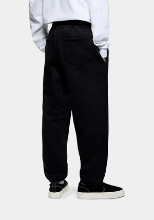 Relaxed Fit 800 GSM Superweight Cuffed Joggers by MKI MIYUKI ZOKU at EQVVS Menswear. Side Model Shot.