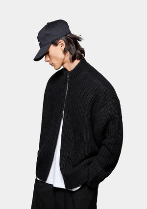 MKI Miyuki Zoku Chunky Rib Knit Track Jacket in Black at EQVVS. Model Angle Shot.