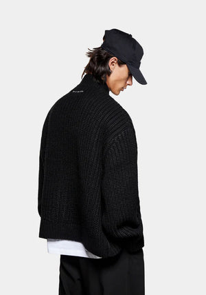 MKI Miyuki Zoku Chunky Rib Knit Track Jacket in Black at EQVVS. Model Back Angle Shot.