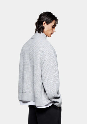 MKI Miyuki Zoku Chunky Rib Knit Track Jacket in Grey at EQVVS. Model Back Angle Shot.