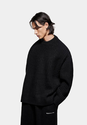 MKI Miyuki Zoku Chunky Rib Knit Crewneck Jumper in Black. Model Angle Shot.