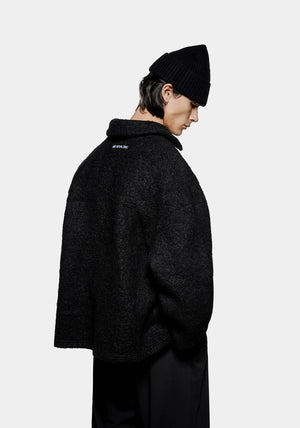 MKI Miyuki Zoku Boucle Overshirt in black. Model shot.