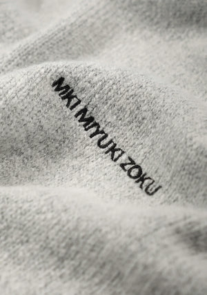 Mohair Blend Knit Track Jacket in Light Grey by MKI MIYUKI ZOKU at EQVVS Menswear. Logo Detail Shot.