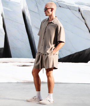 Relaxed Fit Tencel Shorts in Sage Green by MKI MIYUKI ZOKU. EQVVS Campaign Shot.